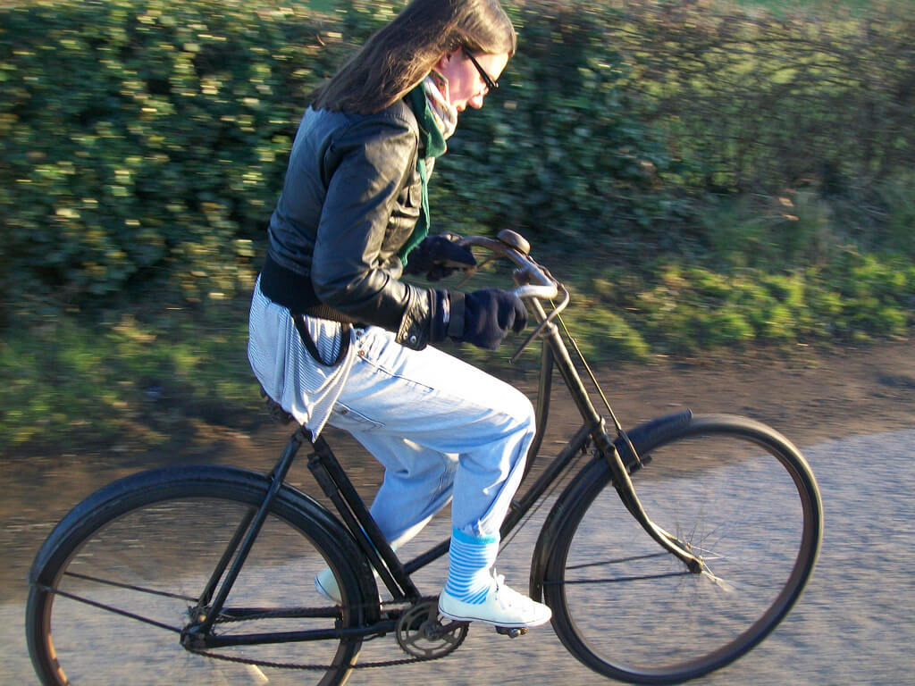 Female Riding Bicycle With No Seat
