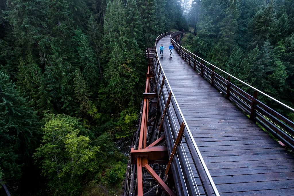 Couple cycling over Kinsol Trestle (Koksilah River Trestle) in the Cowichan Valley.